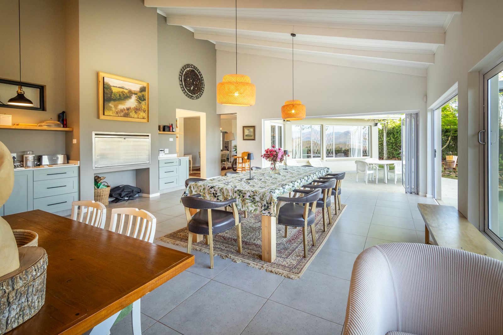A bright dining room with a long table set for guests