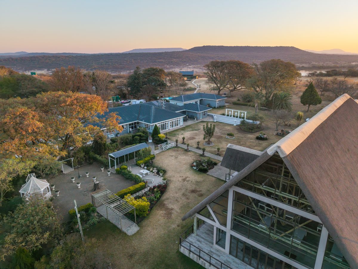Drone photo of a country property and garden at sunset