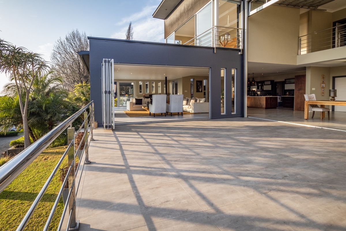 A modern home with a pool deck and open-plan living area